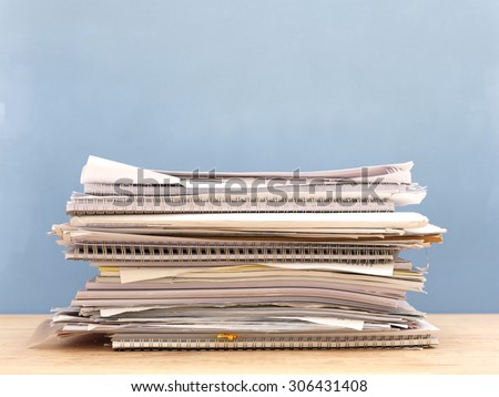 A close up shot of a paper pile on a work desk