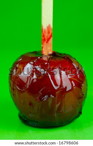 Toffee apples isolated against a green background