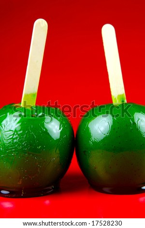 Toffee apples isolated against a red background