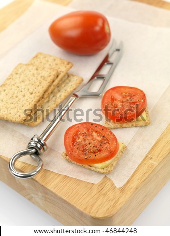 Savory snacks on a wood cutting board isolated against a white background