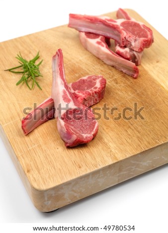 Lamb chops on a chopping board isolated against a white background