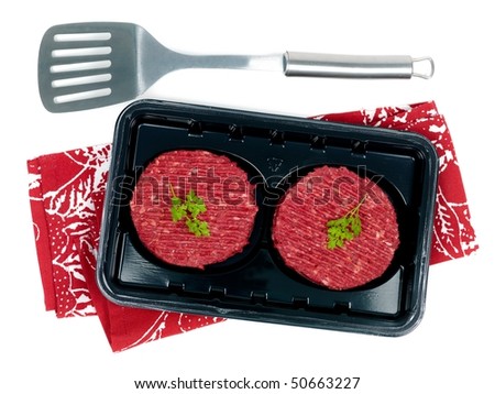 Burger patties in a supermarket packaging tray isolated on a white background