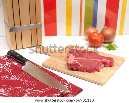A raw T Bone steak on a kitchen bench