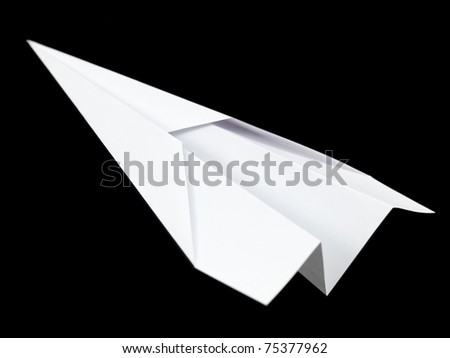 A paper plane isolated against a black background