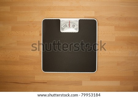 Body bathroom scales on a wooden floor