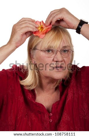 Studio-shot of an elderly woman hair dressing