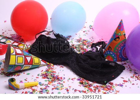 Ladies pants laying at a floor filled with party attributes, balloons and confetti