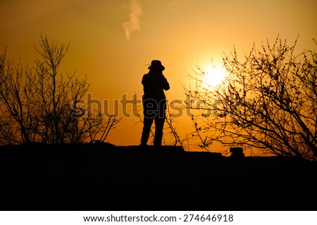 traveler with sunset in dusk, climber silhouette