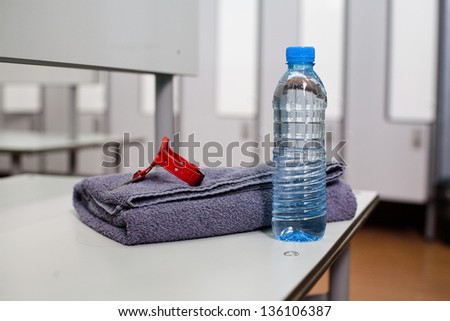 Bottle of water and towel in locker room