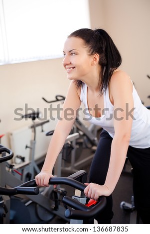 beautiful woman on an exercise bike at the gym
