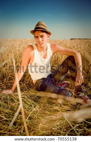 Image of young man  on wheat field