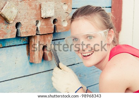 Portrait of smiling young woman making cosmetic alterations of house
