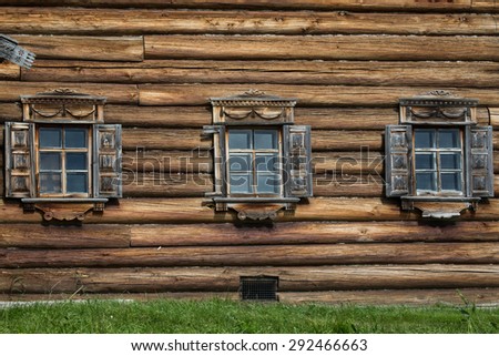 Wooden windows in old houses in the Russian north. Beautiful frames. Woodcarving. Traditional housing construction wood.