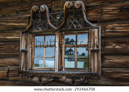 Wooden windows in old houses in the Russian north. Beautiful frames. Woodcarving. Traditional housing construction wood.
