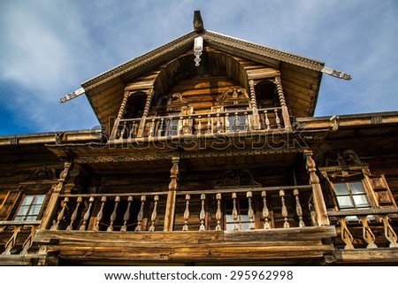 Traditional decoration of wooden houses, windows and balconies. Wooden house in the Russian north.