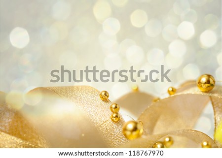Christmas seasonal background with ribbon and golden beads