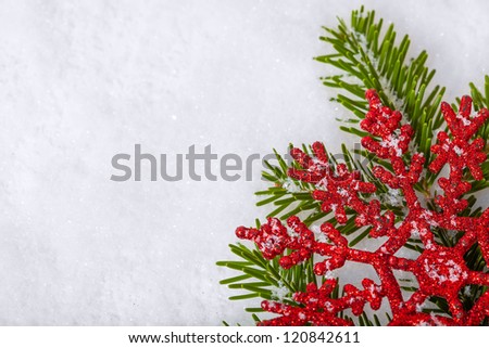 Christmas white seasonal background with snow, red decorations and spruce