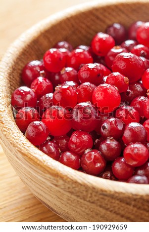 Red bright berries cranberries in wooden dish