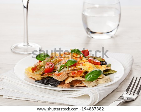 Multicolored cooked pasta meal on light background