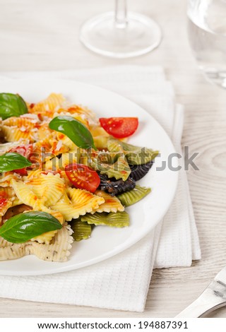 Multicolored cooked pasta meal on light background