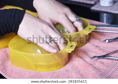 Manicure master at work. Close-up of beautician preparing customers fingers for manicure