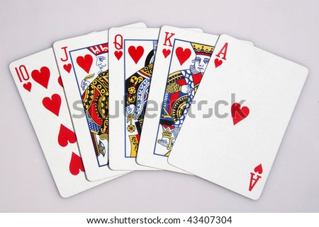 One of the highest hands in poker a heart Royal Flush isolated on white.