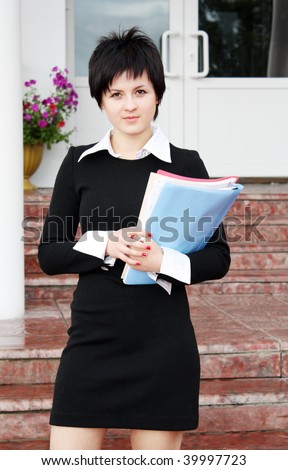 Portrait of the young business woman with official papers