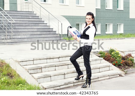 Portrait of the young business woman in the beginning of a career ladder