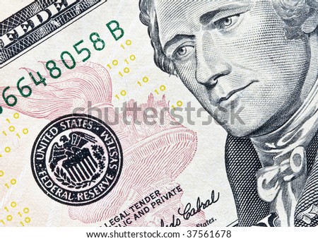 closeup of US ten dollar bill showing Hamilton and the federal reserve seal