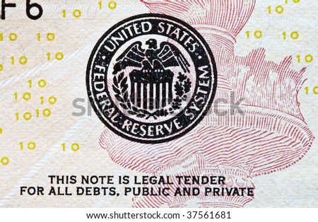 closeup of US federal reserve seal on a ten dollar bill