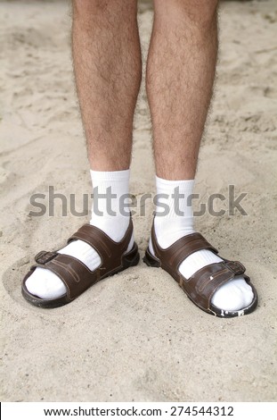 White socks in sandals in sand