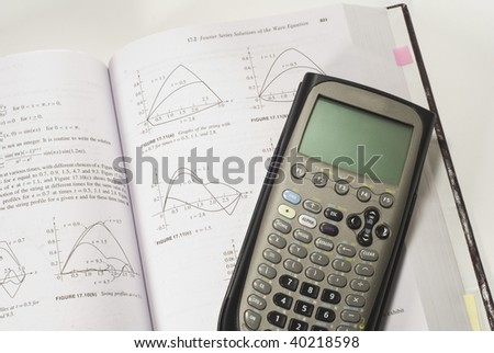 a graphing or scientific calculator resting on a calculus math book