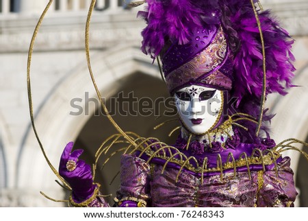 VENICE, ITALY - MARCH 4: A street performer poses in traditional costume for the Carnival celebration in San Marco Square on March 4, 2011 in Venice, Italy.