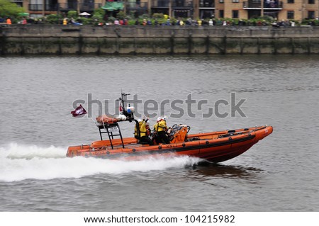 LONDON, UK - JUNE 3: Hundreds of boats muster on the river Thames in Putney for the Thames Diamond Jubilee Pageant to celebrate the Queen\'s Diamond Jubilee on June 3, 2012 in London.