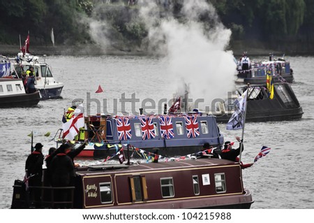 LONDON, UK - JUNE 3: Hundreds of boats muster on the river Thames in Putney for the Thames Diamond Jubilee Pageant to celebrate the Queen's Diamond Jubilee on June 3, 2012 in London.