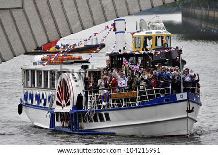 LONDON, UK - JUNE 3: Hundreds of boats muster on the river Thames in Putney for the Thames Diamond Jubilee Pageant to celebrate the Queen\'s Diamond Jubilee on June 3, 2012 in London.