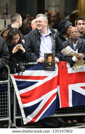 LONDON - UK, APRIL 17: Man holding a portrait of Baroness Thatcher  along the Procession route, on April 17, 2013 in London.