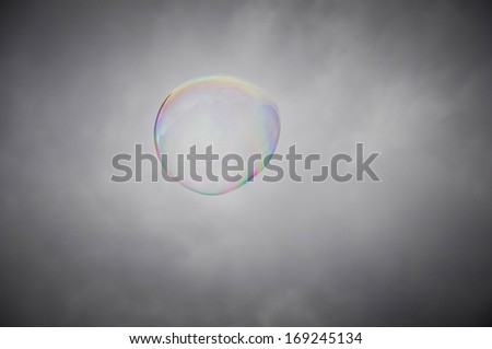 Soap bubble against a cloudy sky background