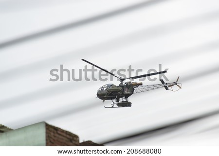 KATHMANDU, NEPAL - AUGUST 3, 2014: Nepalese army helicopter checking the surroundings before Indian Prime Minister Narendra Modi arrives in Kathmandu on a 2-day official Nepal visit.