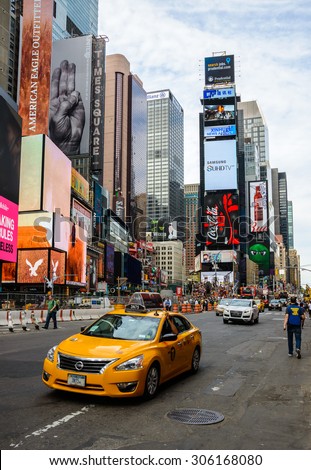 NEW YORK, USA - AUGUST 7, 2015: A yellow cab drives past Times Square.