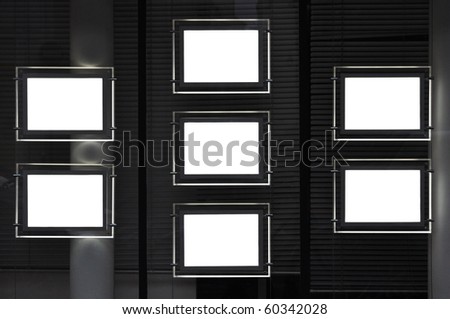 Estate agency window at night