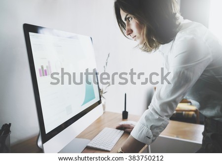 Close up of young businesswoman in white shirt looking at computer with the accounting report of the finance, woman working at her office with technology achievement research strategy concept