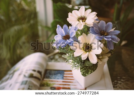 Flower in vase on top of book - Vintage effect style pictures
