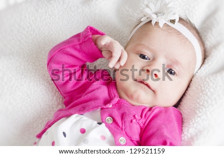Newborn baby girl portrait white background