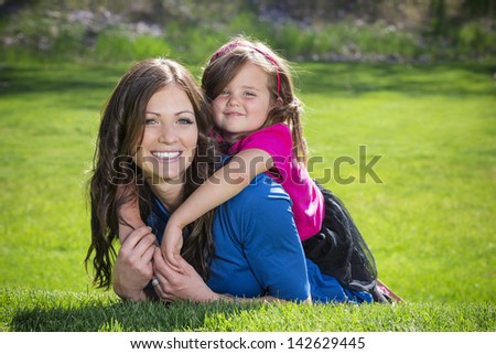 Mother and daughter having fun together outdoors