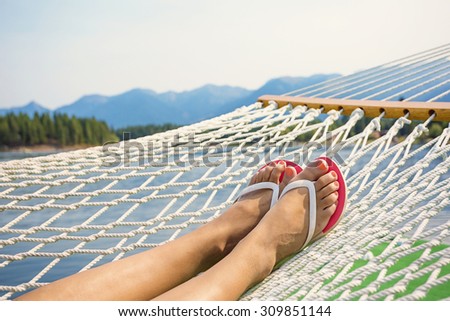 Woman relaxing in a hammock on a beautiful Mountain Lake