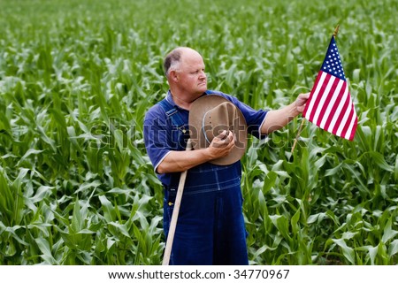 Old farmer displays his American pride by holding the U.S. flag