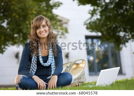 Female Student Portrait sitting outside an academic building