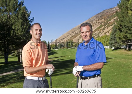Two male golfers playing golf together