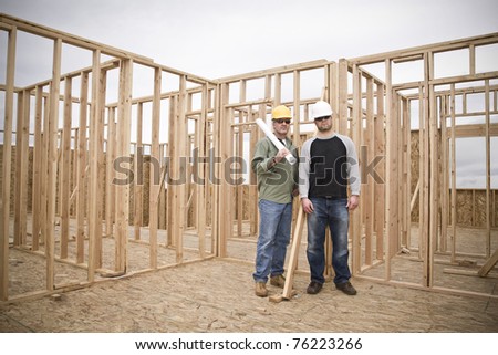 Building Contractors standing in an unfinished home